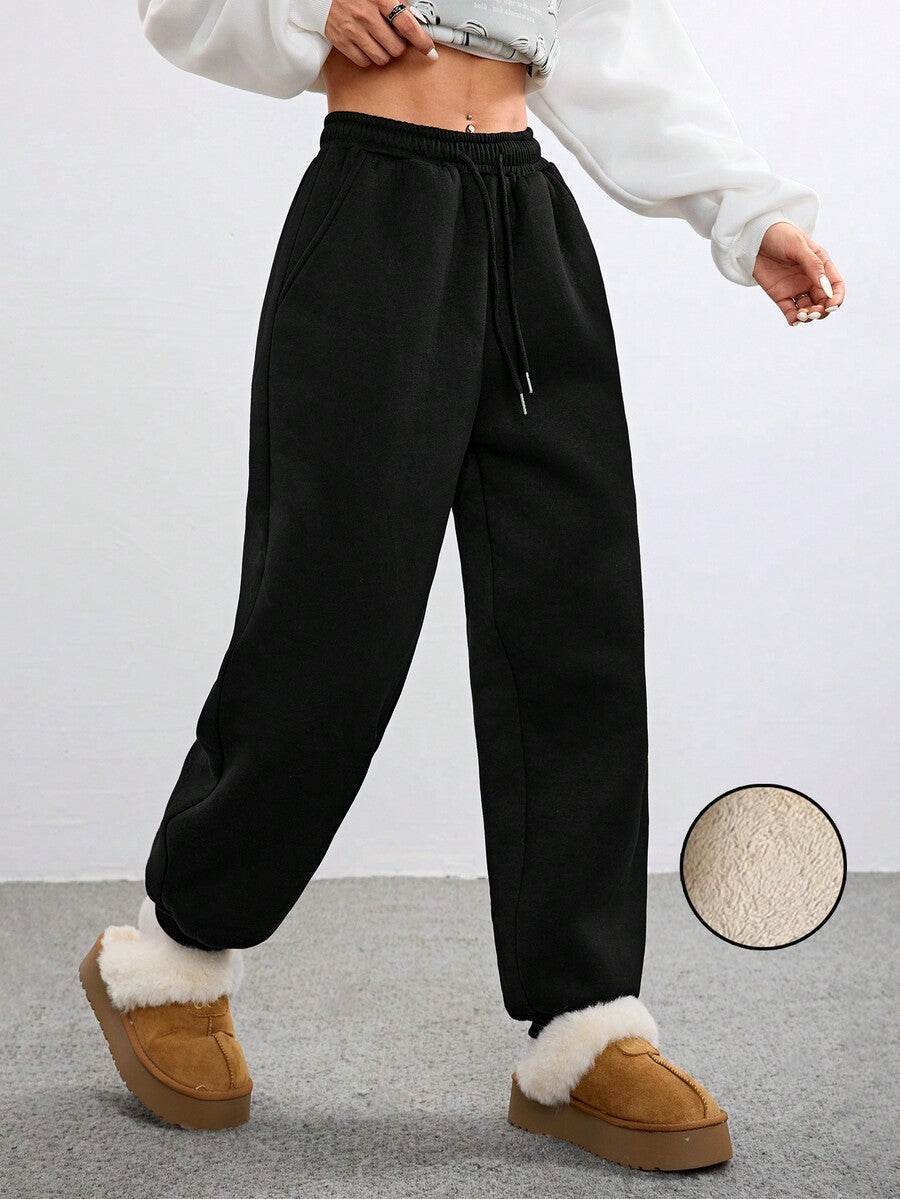 Women's black casual sweatpants featuring an adjustable drawstring waistband, loose straight cut, and soft warm knitted fabric.