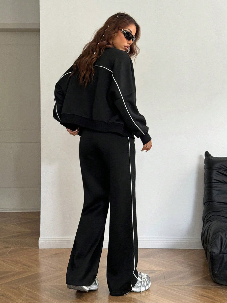 Women's two-piece casual set featuring a long sleeve zip-front hoodie and matching drawstring pants.