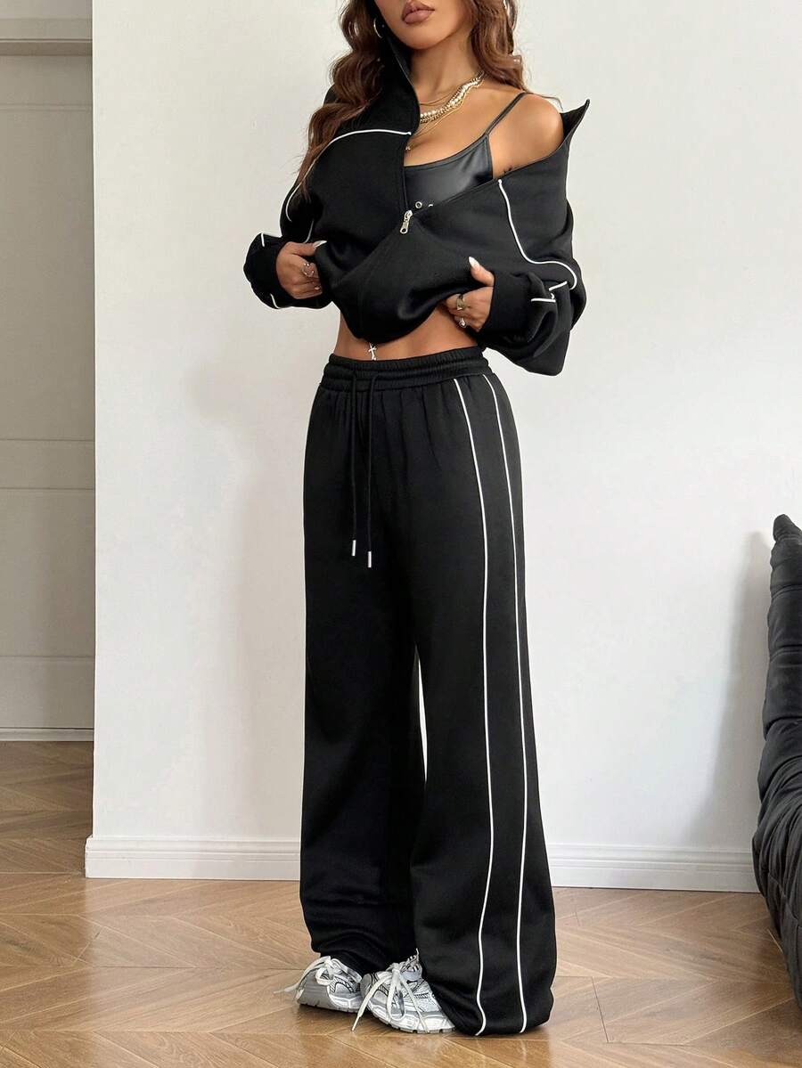 Women's two-piece casual set featuring a long sleeve zip-front hoodie and matching drawstring pants.