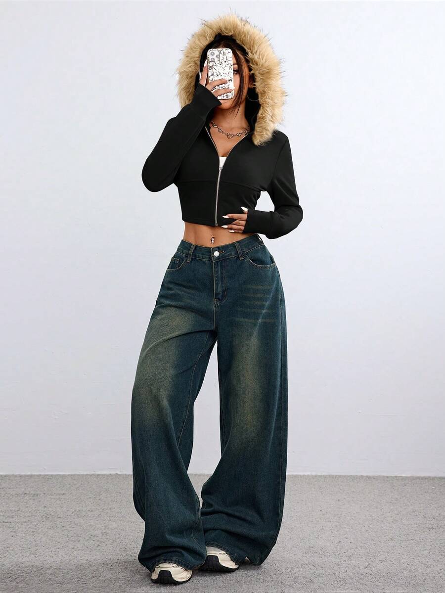 Front view of women's black zip-up hooded crop top with long sleeves and fuzzy faux fur fleece details