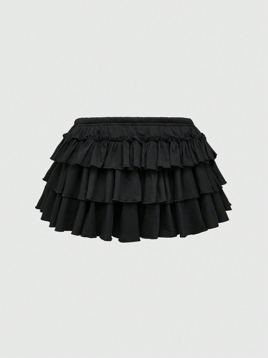 Women's low waist tiered mini skirt featuring ruffled hem layers in knitted stretch fabric.