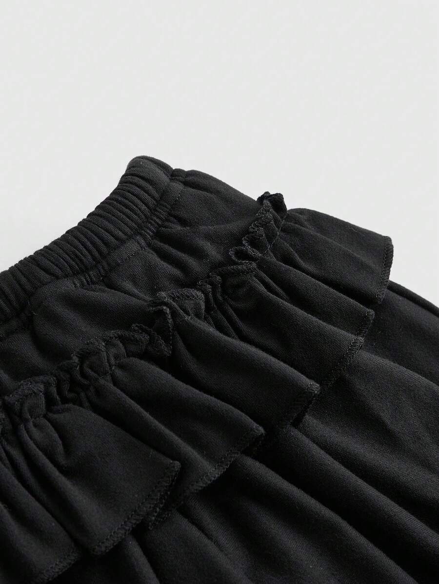 Women's low waist tiered mini skirt featuring ruffled hem layers in knitted stretch fabric.