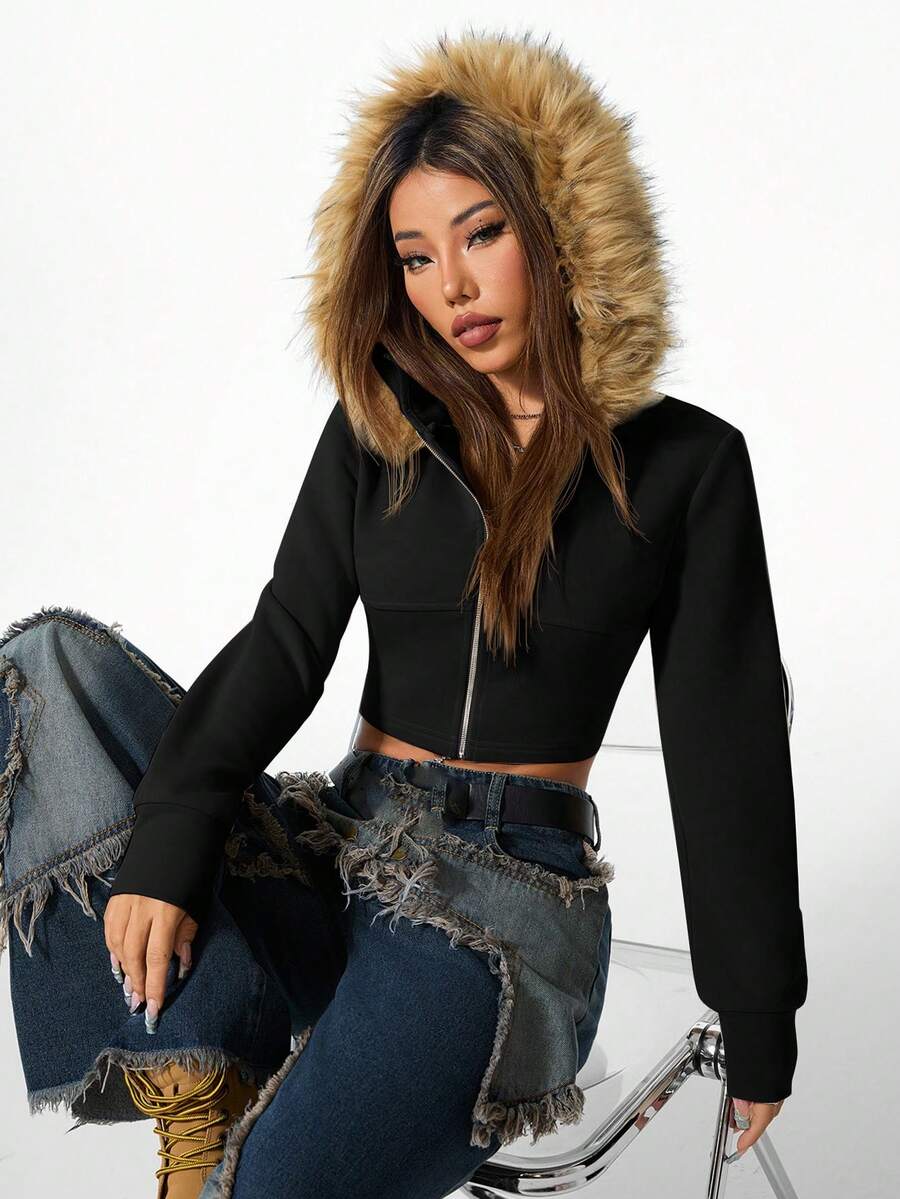 Front view of women's black zip-up hooded crop top with long sleeves and fuzzy faux fur fleece details
