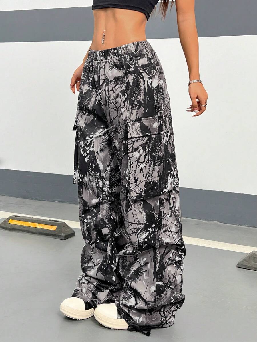 Women's high waist wide leg cargo pants featuring a black and white tree branch print and adjustable drawstring closure.