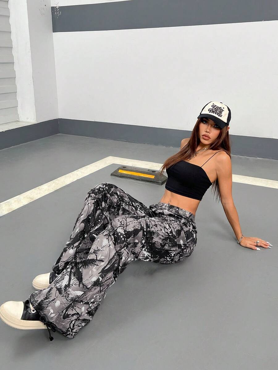 Women's high waist wide leg cargo pants featuring a black and white tree branch print and adjustable drawstring closure.