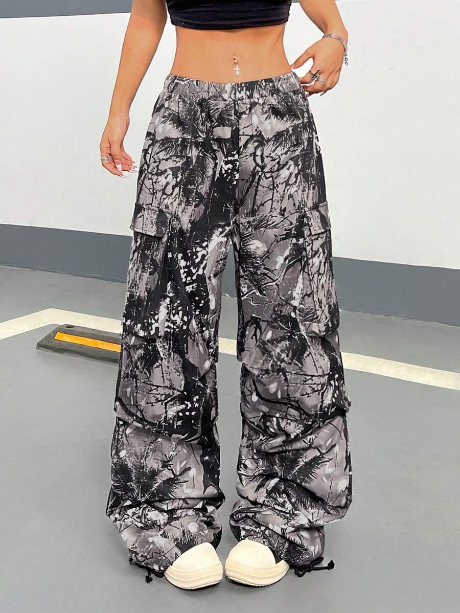 Women's high waist wide leg cargo pants featuring a black and white tree branch print and adjustable drawstring closure.