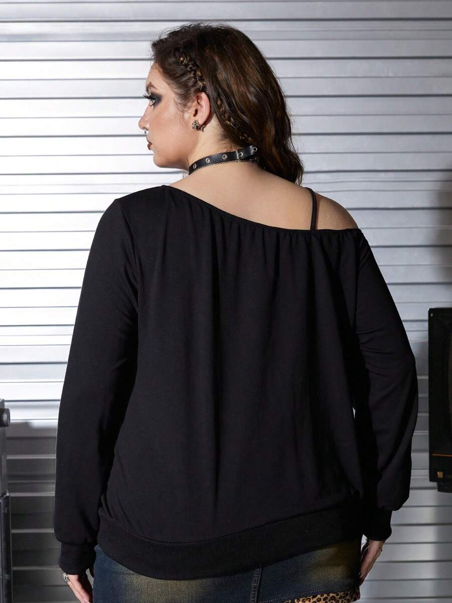 Black women's loose long sleeve gothic sweatshirt with an asymmetrical neckline, strap detail, and fang graphic print.