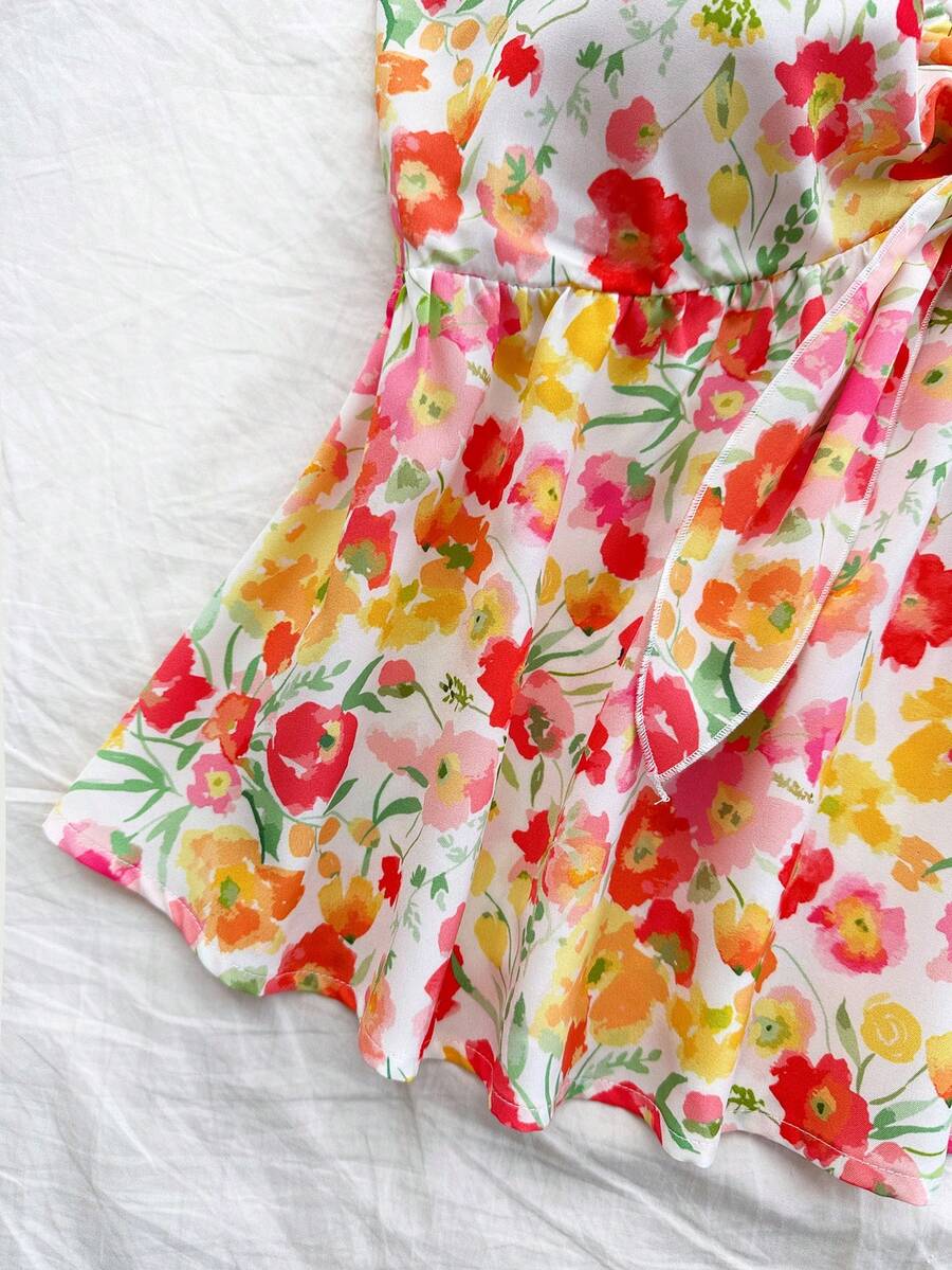 Women's woven strapless bandeau top in multicolor floral print featuring ruffle trim, frill details, and a flared hem.