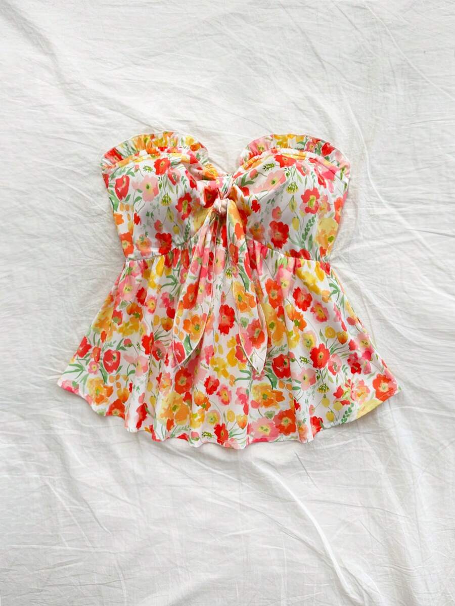 Women's woven strapless bandeau top in multicolor floral print featuring ruffle trim, frill details, and a flared hem.