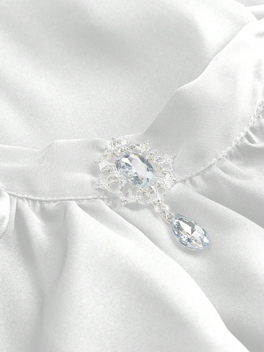 Vintage gothic style women's blouse with stand collar, detachable ruffled bow tie, gem pendant, and flare sleeves