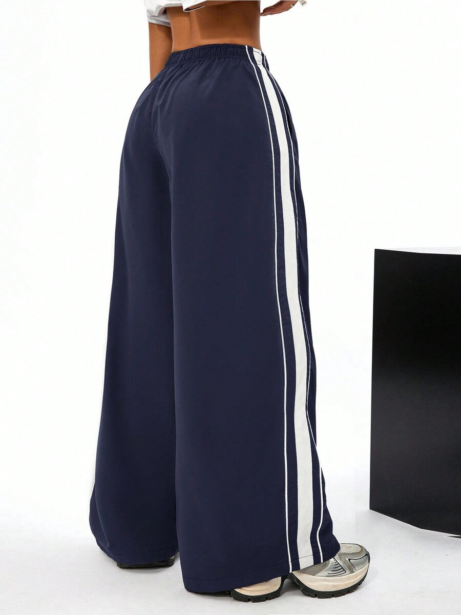 Women's navy blue wide leg sweatpants with casual loose fit, side stripe detail, and elastic waist