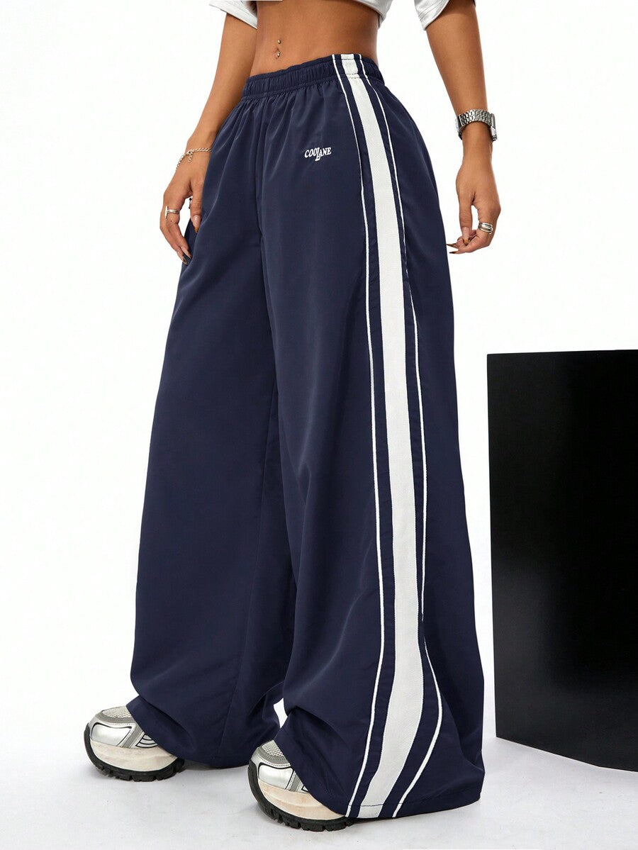 Women's navy blue wide leg sweatpants with casual loose fit, side stripe detail, and elastic waist