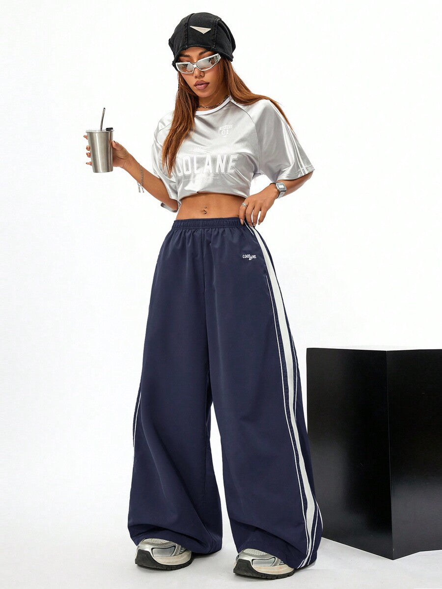 Women's navy blue wide leg sweatpants with casual loose fit, side stripe detail, and elastic waist