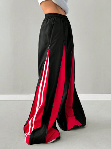 Women's loose fit wide leg pants featuring a black and red contrast patchwork design with an elastic drawstring waist.