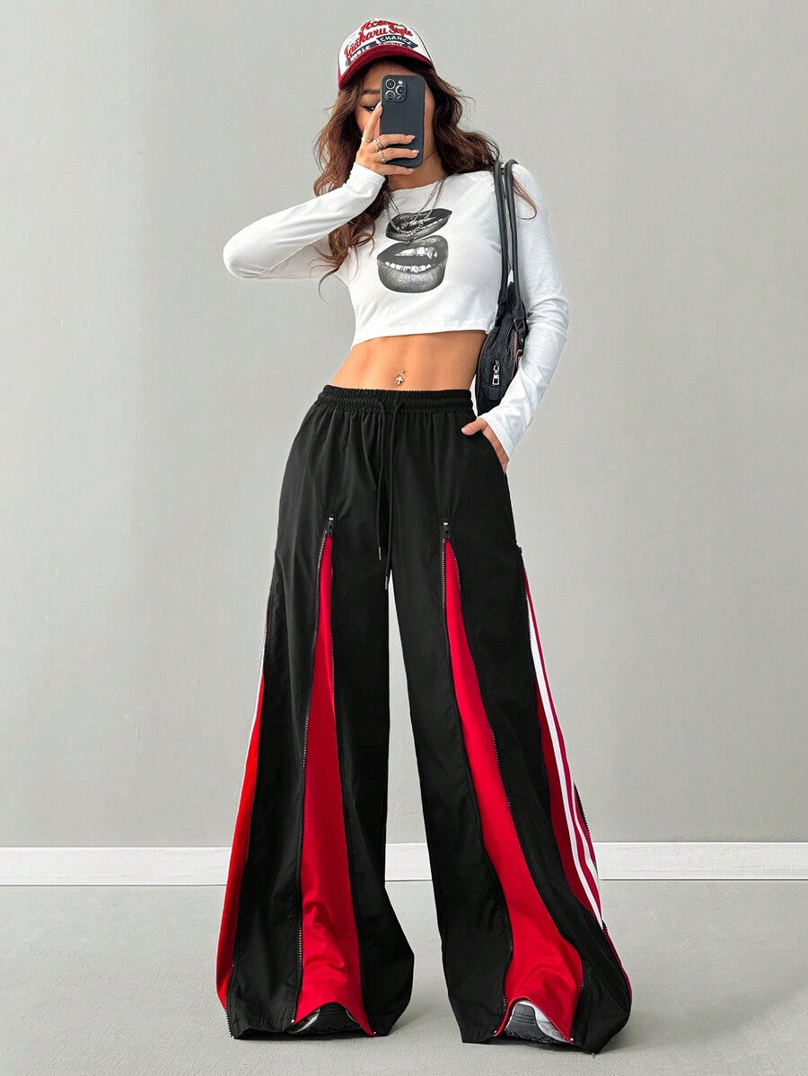 Women's loose fit wide leg pants featuring a black and red contrast patchwork design with an elastic drawstring waist.