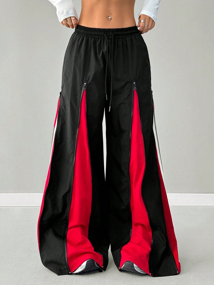 Women's loose fit wide leg pants featuring a black and red contrast patchwork design with an elastic drawstring waist.