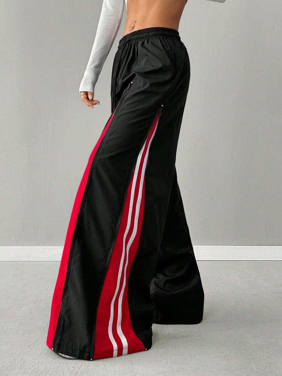 Women's loose fit wide leg pants featuring a black and red contrast patchwork design with an elastic drawstring waist.