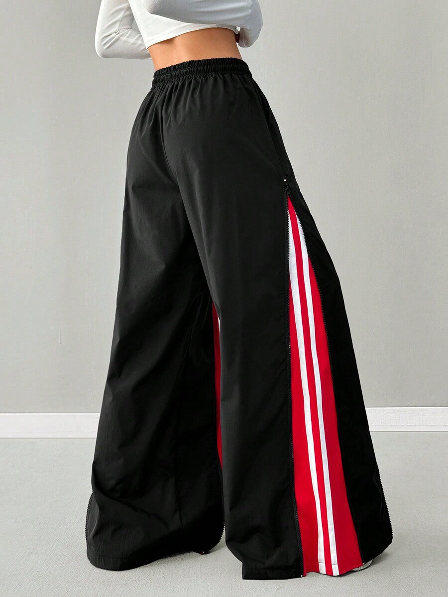 Women's loose fit wide leg pants featuring a black and red contrast patchwork design with an elastic drawstring waist.