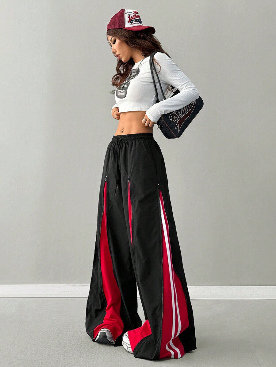 Women's loose fit wide leg pants featuring a black and red contrast patchwork design with an elastic drawstring waist.