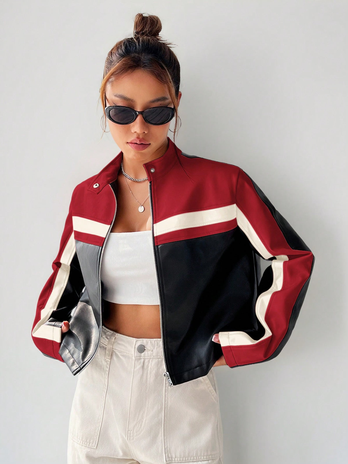 Women's black striped zip up crop jacket featuring a stand collar and long regular sleeves.