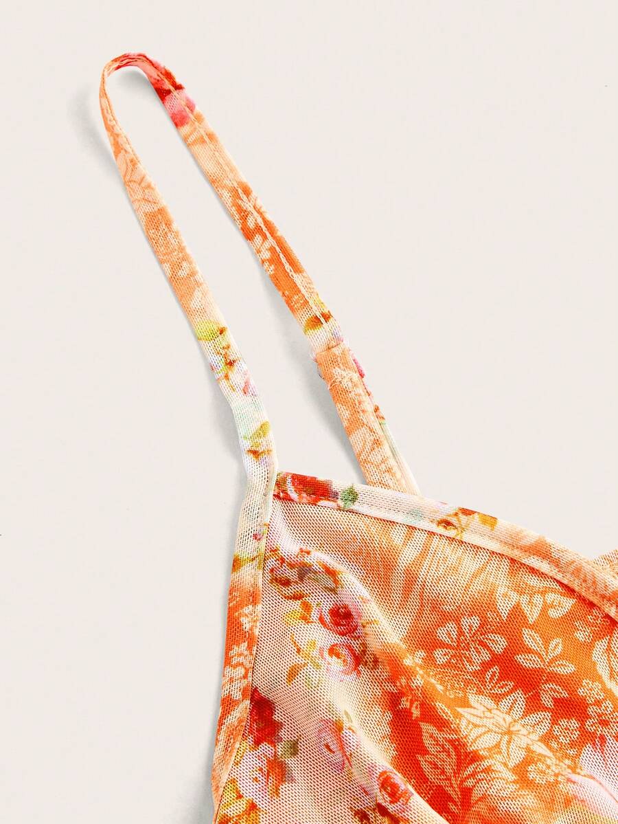 Floral multicolor mesh spaghetti strap cami tank top with backless design, ruffle hem, lettuce trim, and flared long loose fit.