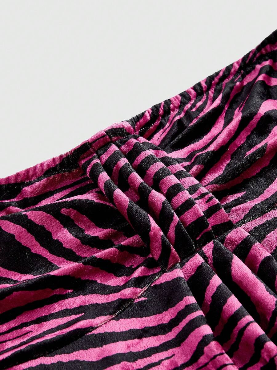Women's strapless hot pink zebra print ruched tube top featuring a flared hem and slim fit knitted fabric.