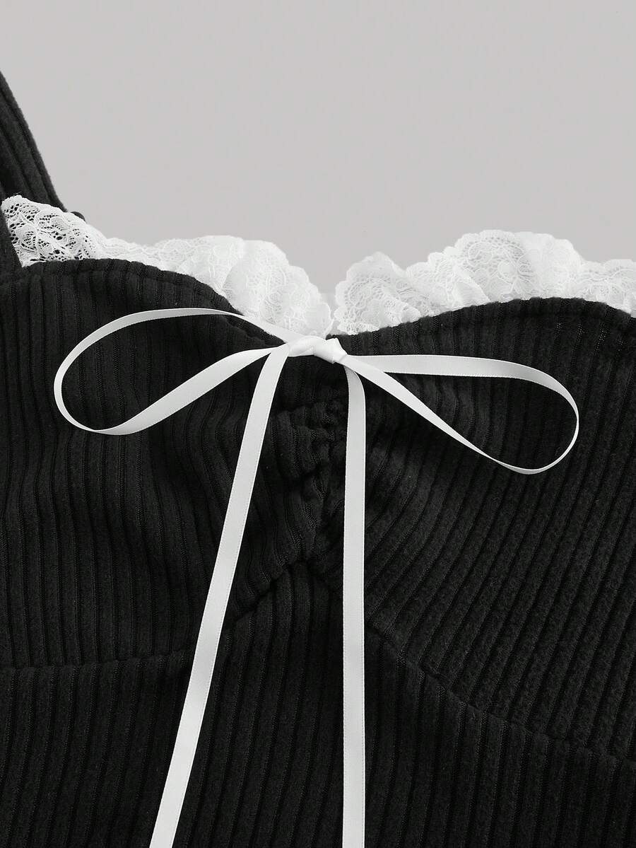 Black crop camisole top for women featuring shoulder straps, cold shoulder sleeves, drawstring detail, and frill trim on plain knitted fabric.