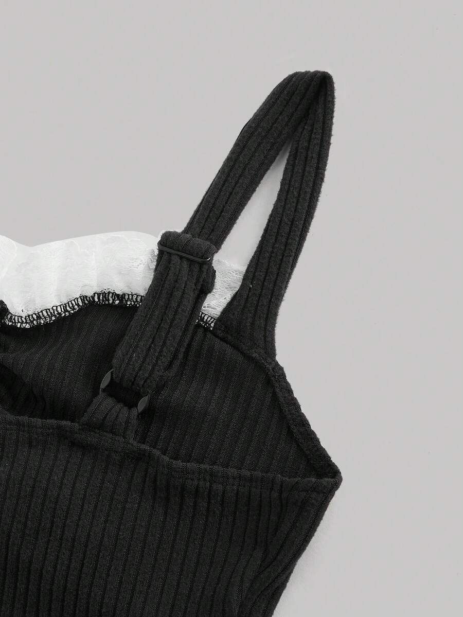Black crop camisole top for women featuring shoulder straps, cold shoulder sleeves, drawstring detail, and frill trim on plain knitted fabric.