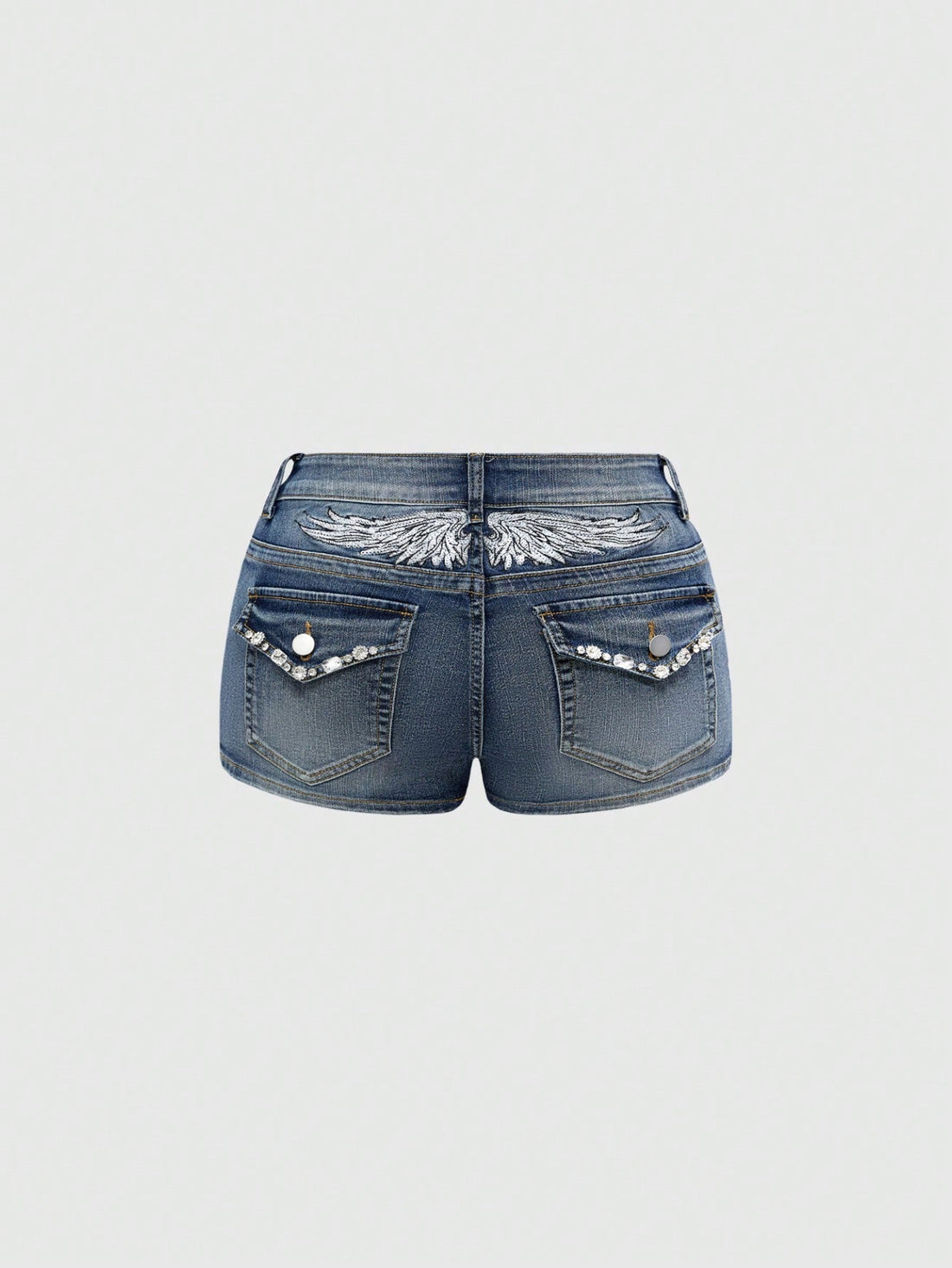 Blue ultra low waist mini shorts with ripped details, zipper fly, button closure, back wing embroidery, and rhinestone decor in a Y2K grunge punk style.