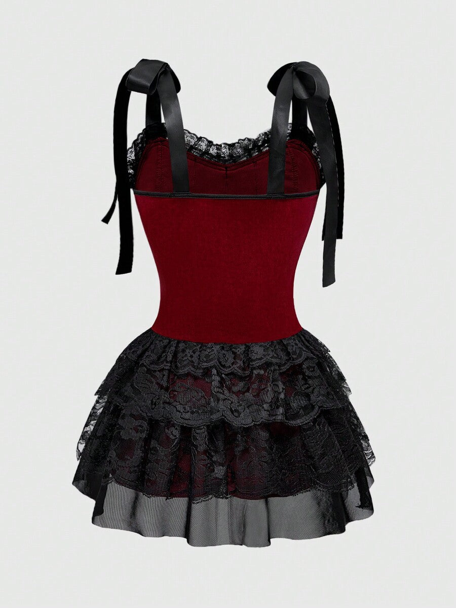 Gothic velvet halter mini dress with contrast lace trim, bow detail, lace-up accents, arm sleeves, layered hem, and cross pendant.