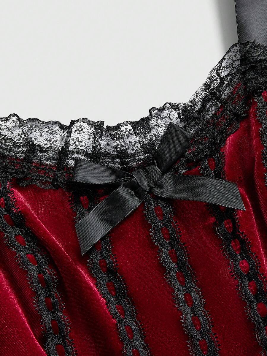 Gothic velvet halter mini dress with contrast lace trim, bow detail, lace-up accents, arm sleeves, layered hem, and cross pendant.