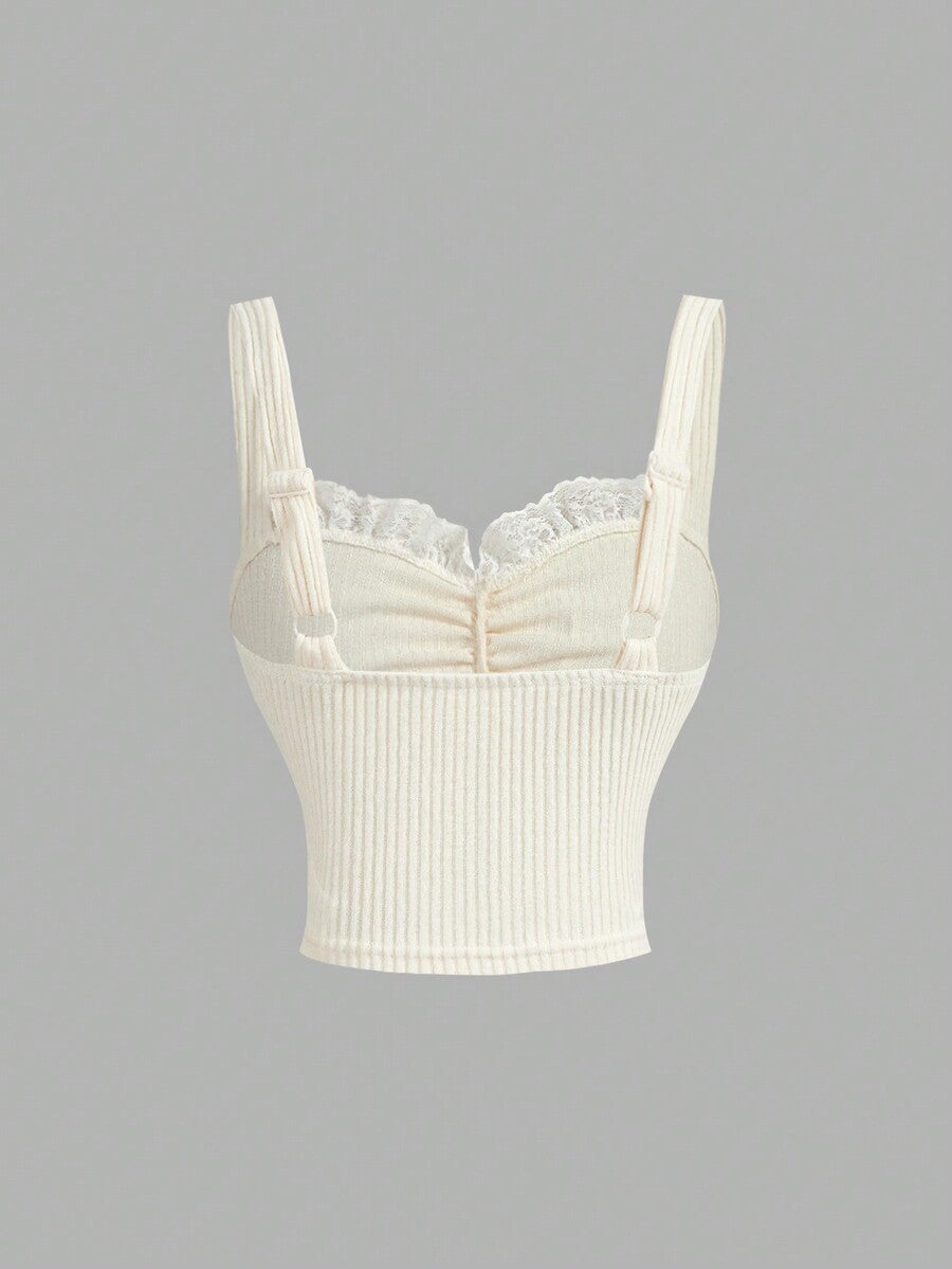 Black crop camisole top for women featuring shoulder straps, cold shoulder sleeves, drawstring detail, and frill trim on plain knitted fabric.