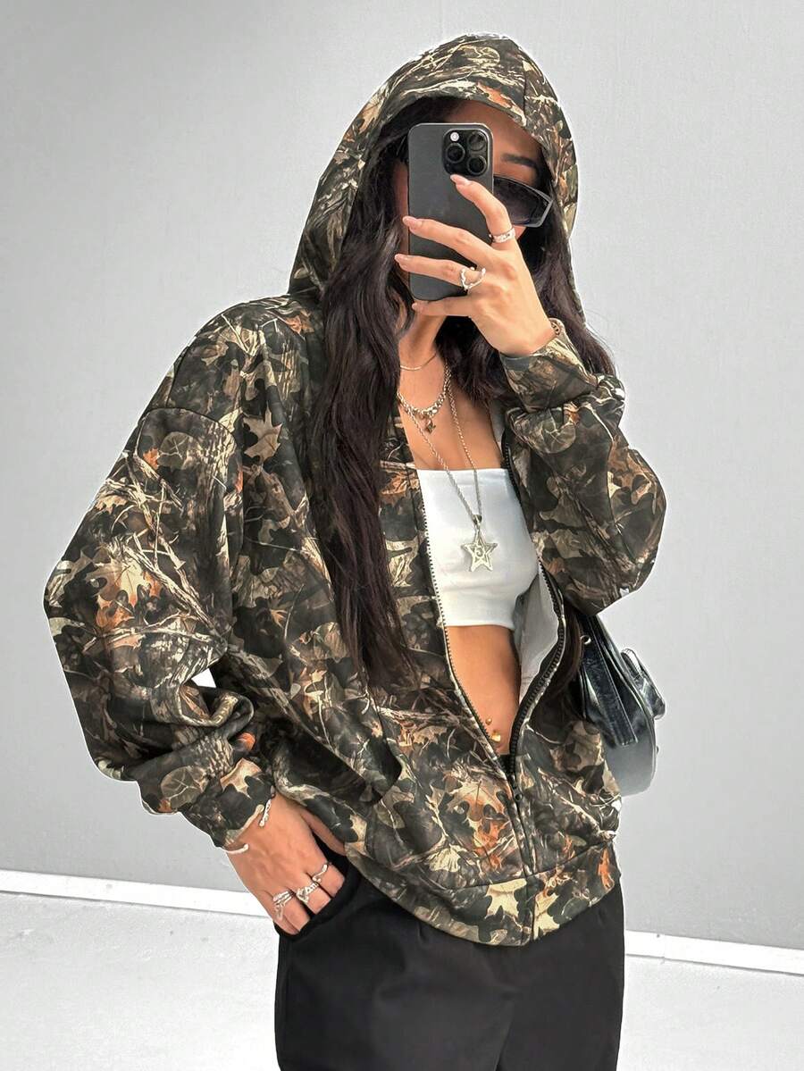 Women's army green camo zip up hoodie with drop shoulder sleeves, front pockets, and drawstring hood