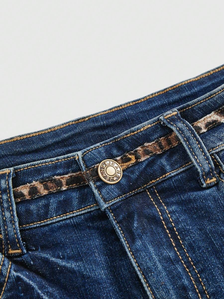 Women's super low waist shorts with leopard print embroidery, button and zipper closure, and raw hem detailing.