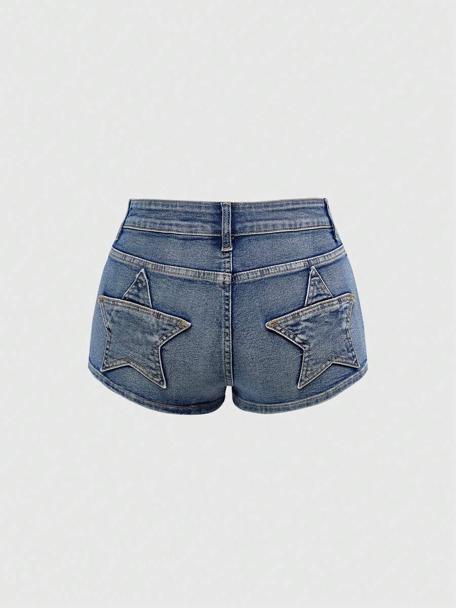 Women's ultra low waist mini shorts with back pockets, zipper fly, button detail, random print, and star patch in a grunge punk Y2K style.