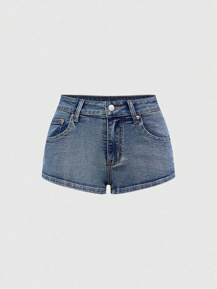 Women's ultra low waist mini shorts with back pockets, zipper fly, button detail, random print, and star patch in a grunge punk Y2K style.