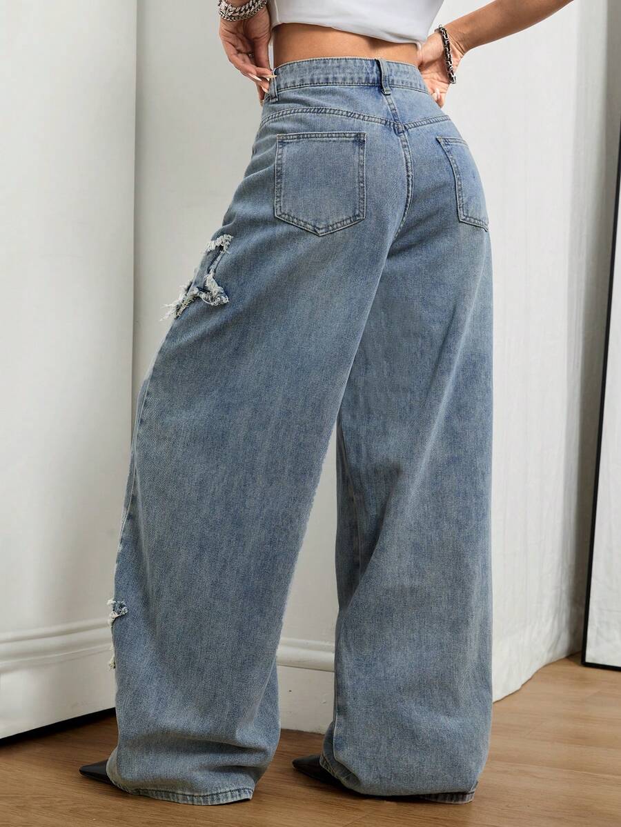 Front view of women's loose wide leg denim jeans featuring a mid waist, classic front pockets, and a zipper fly closure.