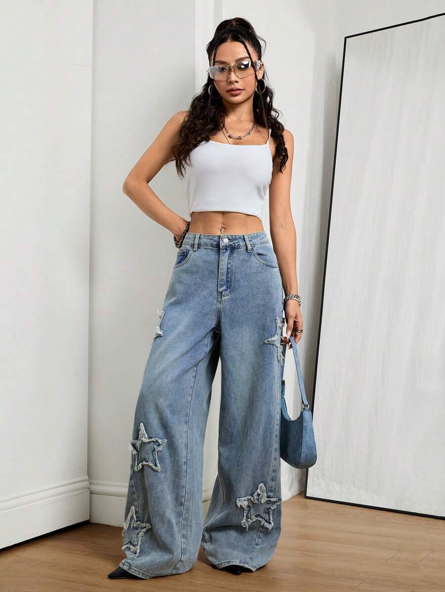 Front view of women's loose wide leg denim jeans featuring a mid waist, classic front pockets, and a zipper fly closure.