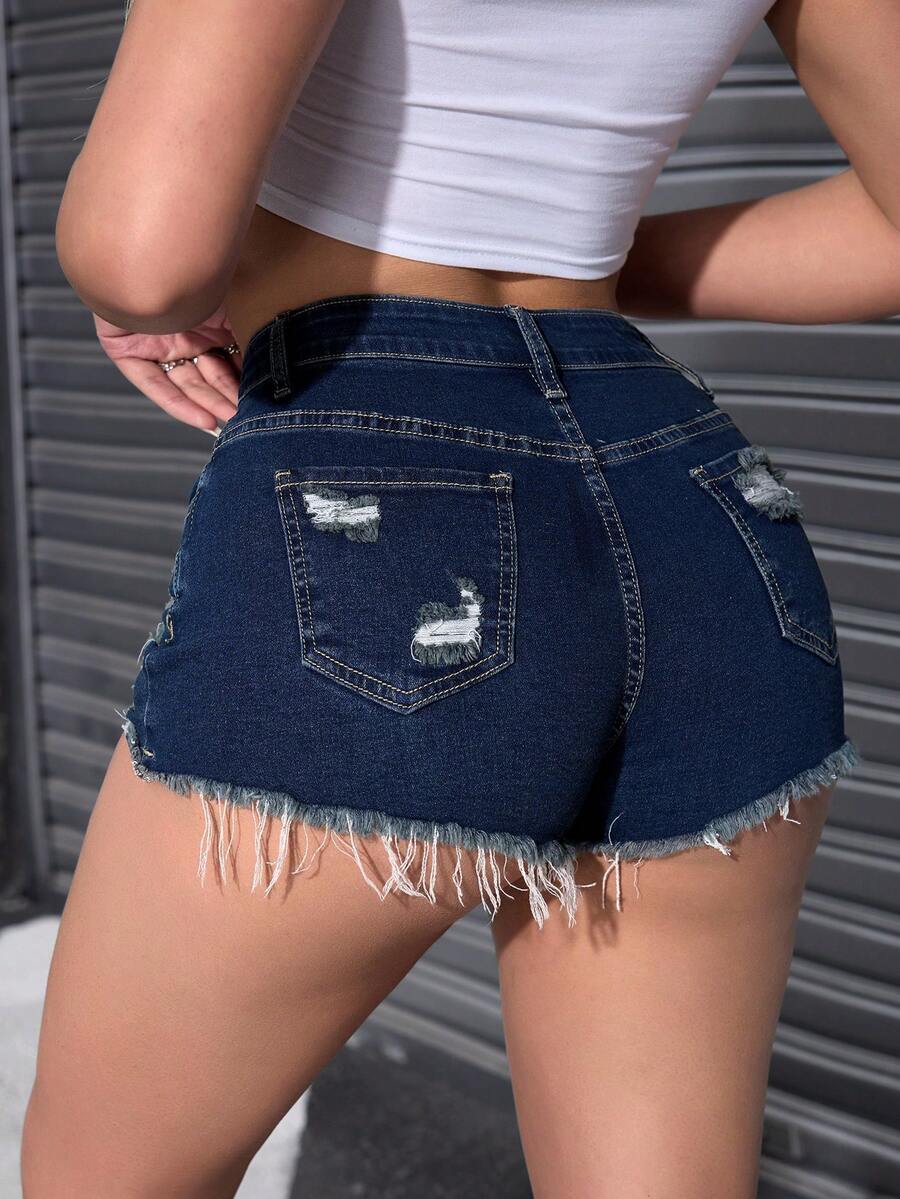Women's solid color shorts with zipper fly, button closure, pockets, ripped details, and raw hem in a casual straight-leg short length