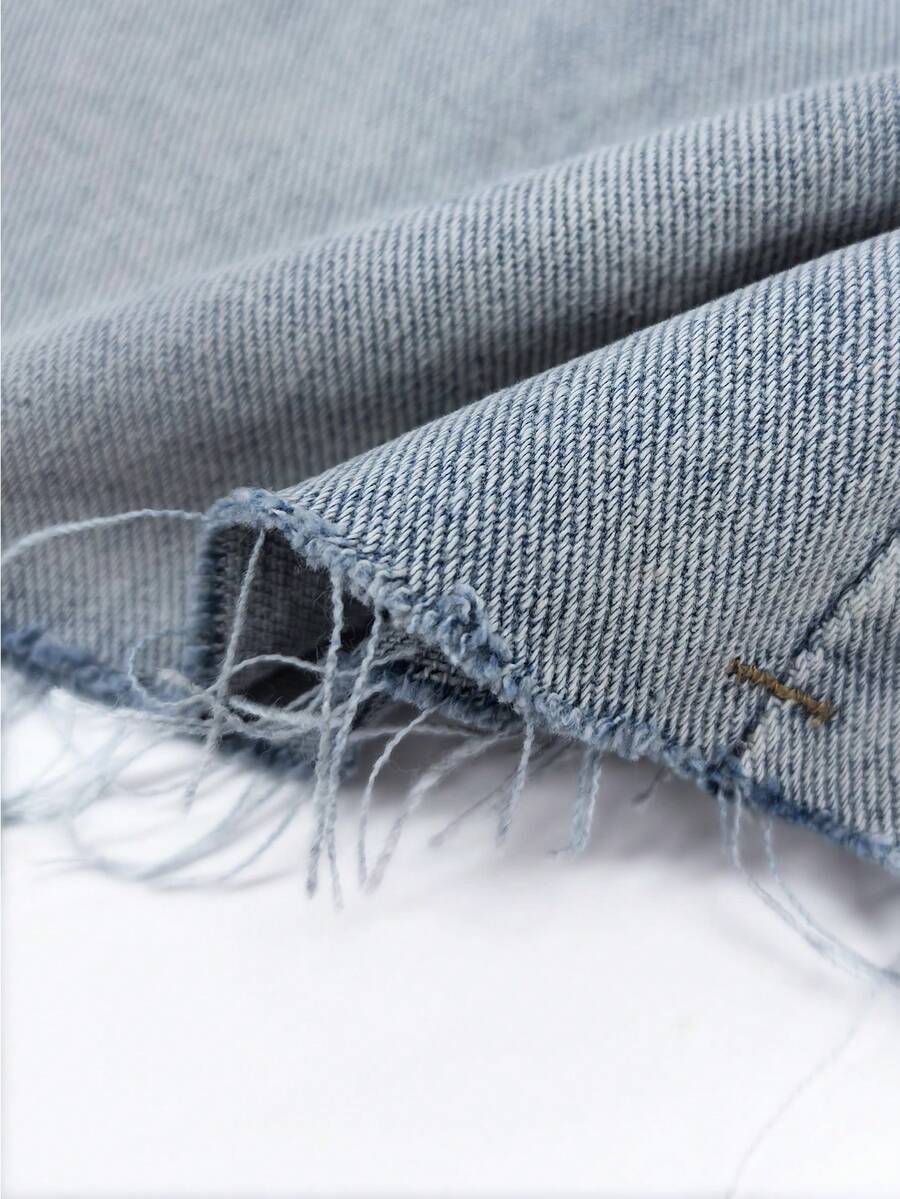 Y2K distressed mini skort with button and pocket details, natural mid waist, regular fit, and casual streetwear styling.