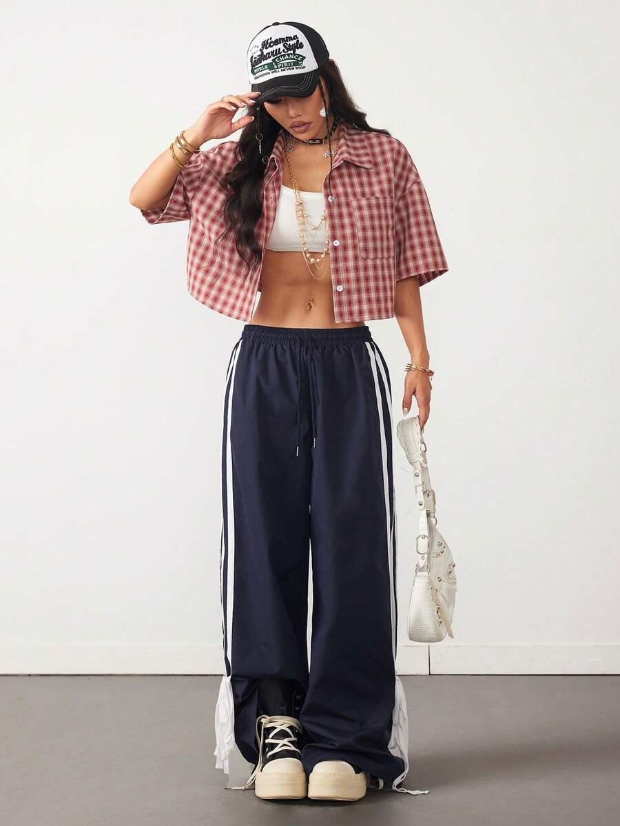 Women's plaid crop shirt with button front, chest pocket, short sleeves, and loose casual fit.