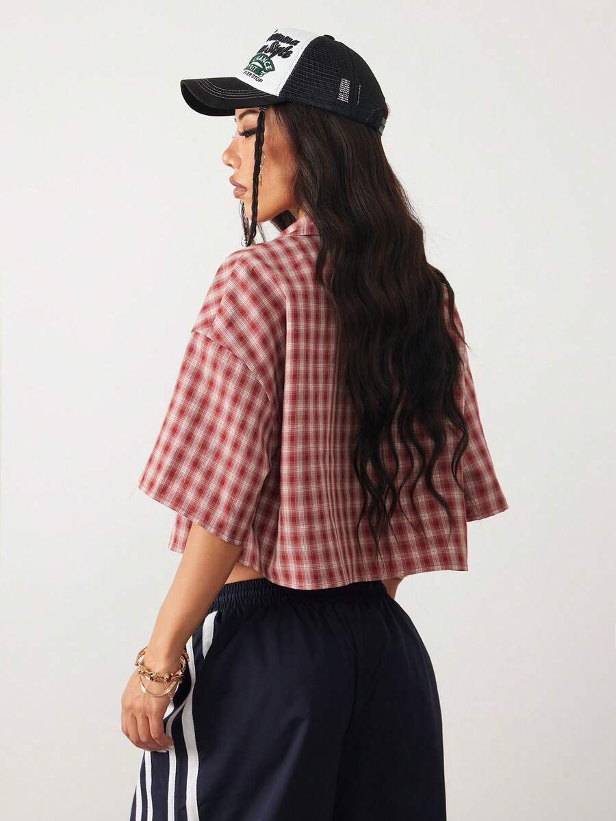 Women's plaid crop shirt with button front, chest pocket, short sleeves, and loose casual fit.
