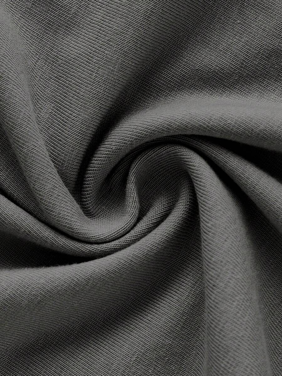 Dark grey women's two-piece outfit featuring a spaghetti strap cami crop top with contrast binding and matching wide-leg drawstring knit lounge pants.