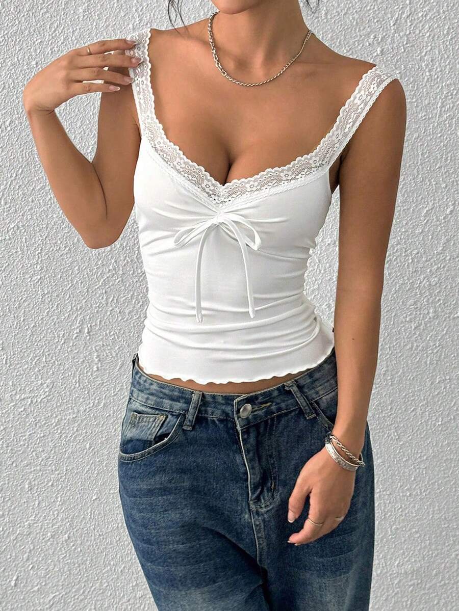 Women's slim fit casual camisole featuring wide shoulder straps, contrast lace trim, a front knot, and ruched details.