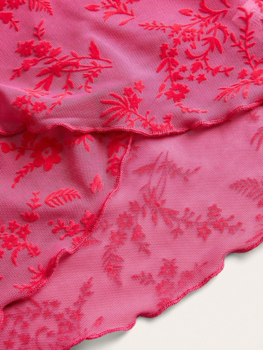 Women's cropped floral flocked camisole with spaghetti straps, backless styling, lettuce trim, asymmetrical hem, and slim fit