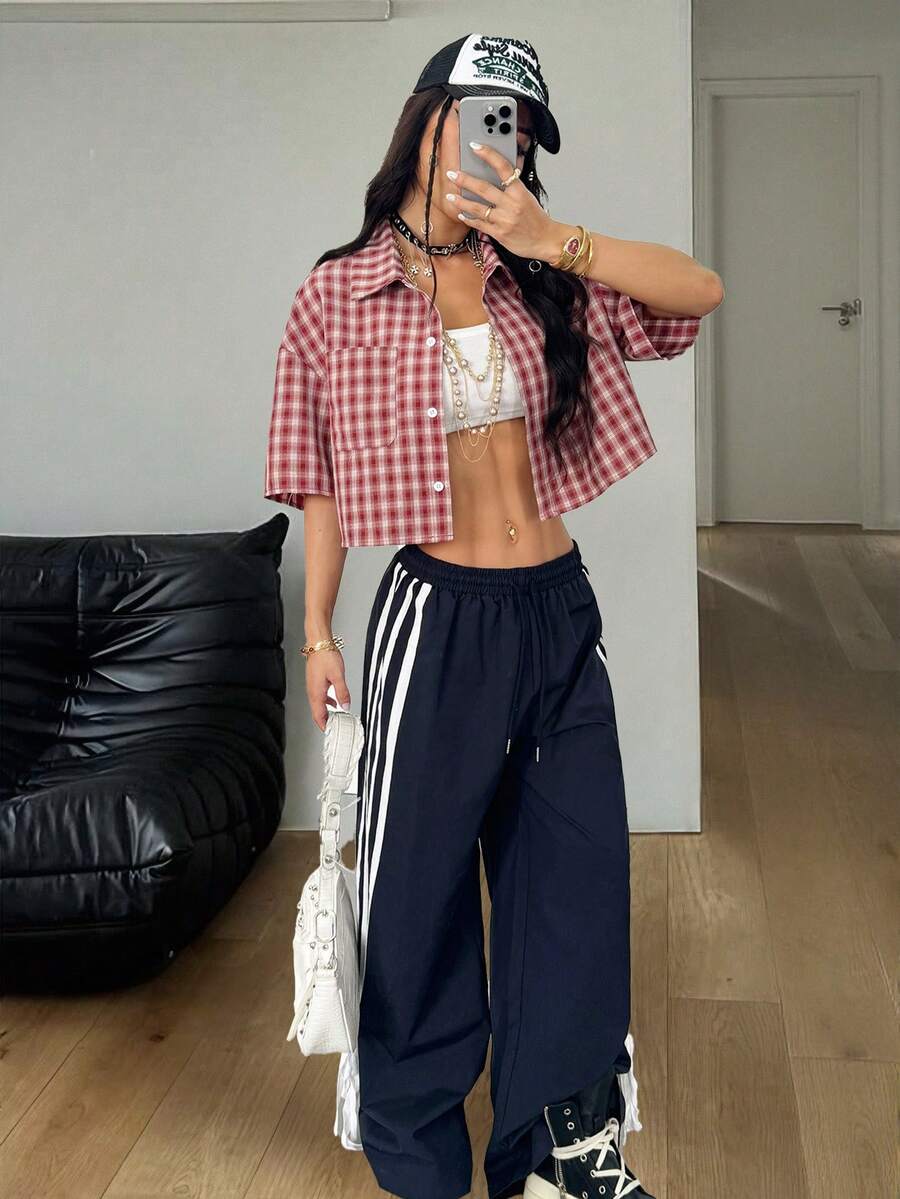 Women's plaid crop shirt with button front, chest pocket, short sleeves, and loose casual fit.