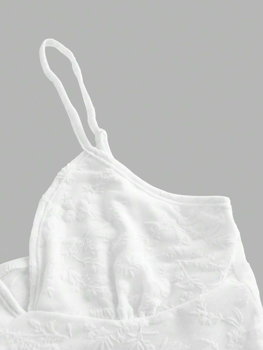 Women's cropped floral flocked camisole with spaghetti straps, backless styling, lettuce trim, asymmetrical hem, and slim fit