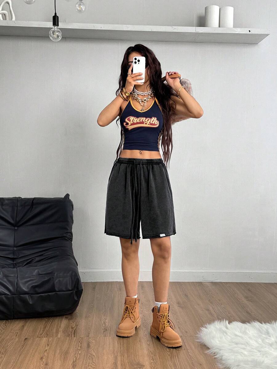 Women's loose fit dark grey track Bermuda shorts featuring an elastic drawstring waistband and side slit hem.