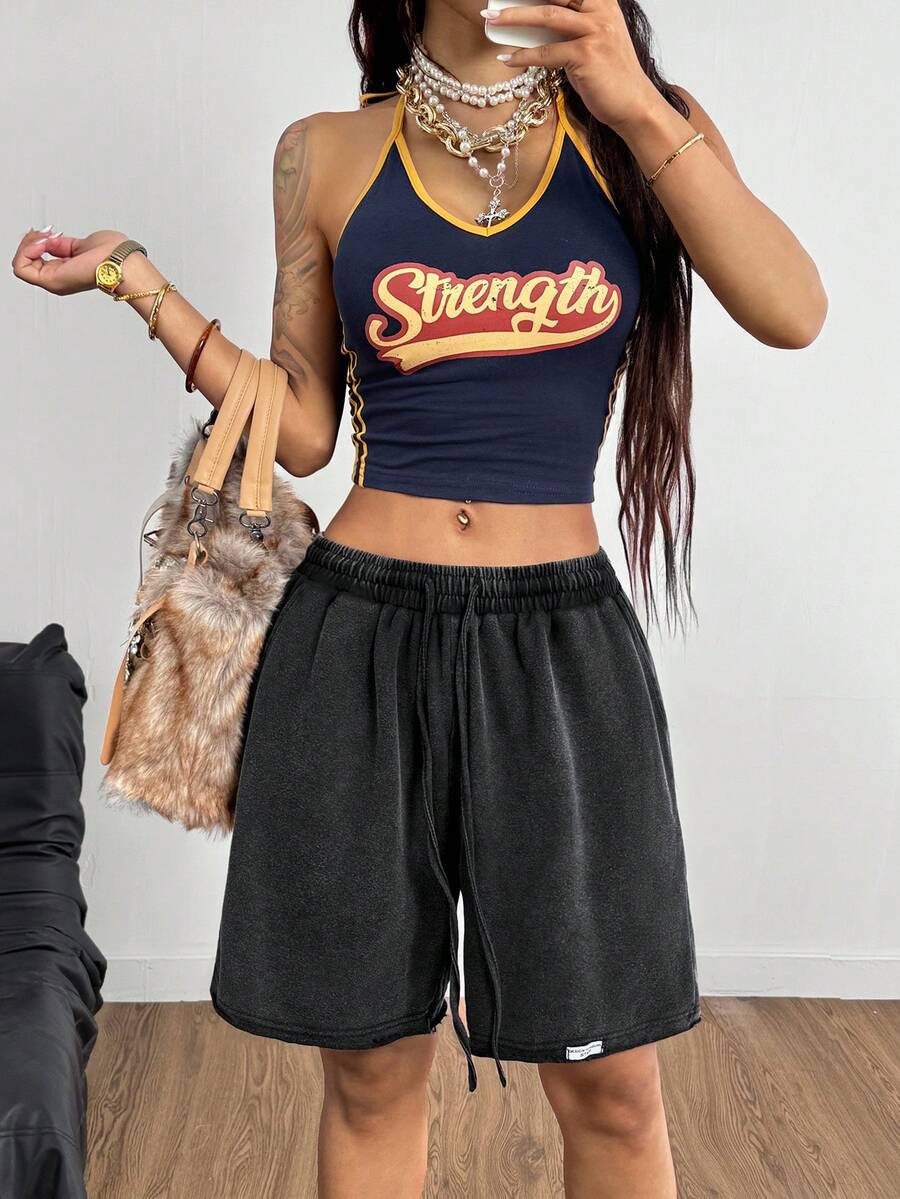 Women's loose fit dark grey track Bermuda shorts featuring an elastic drawstring waistband and side slit hem.