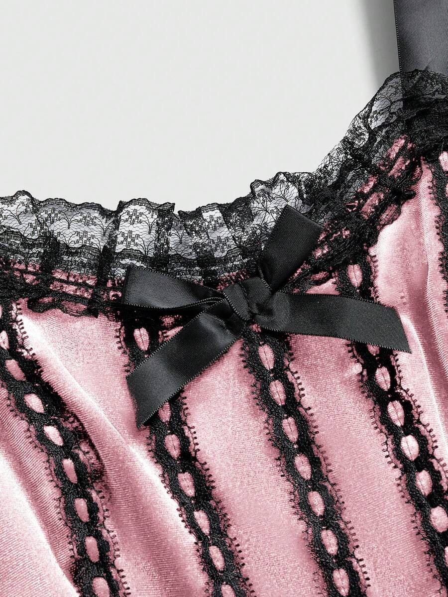 Gothic velvet halter mini dress with contrast lace trim, bow detail, lace-up accents, arm sleeves, layered hem, and cross pendant.